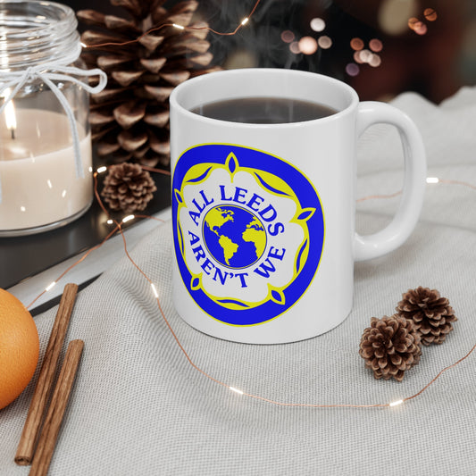 "All Leeds Aren't We" enamel mug on a festive table with candles and pine cones